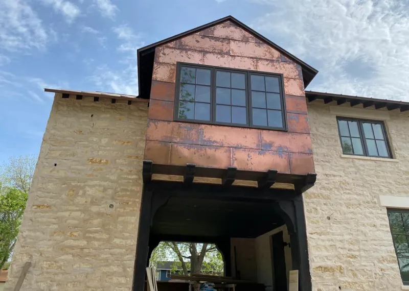 Copper metal panel facade on a stone building for Roof Repair in Summerlin South